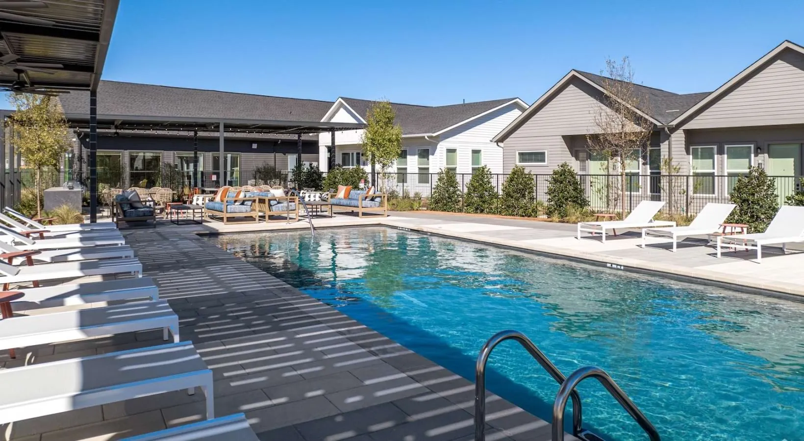 Large pool with deck and lounge chairs