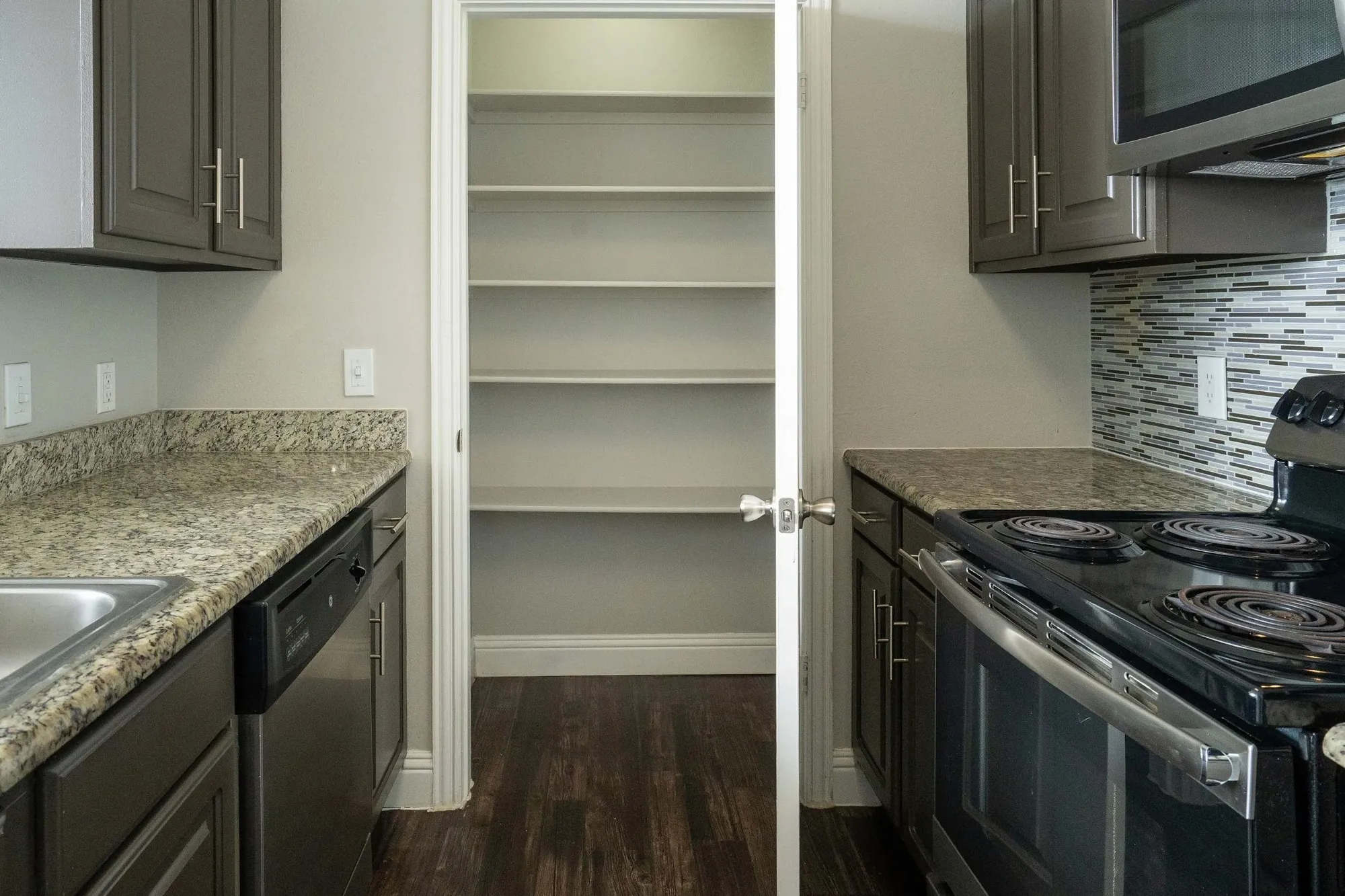 Kitchen with pantry storage and stainless range at 29Fifty
