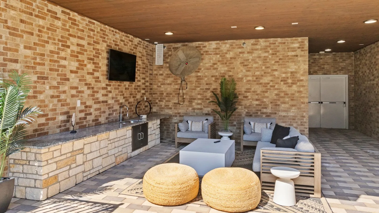 A patio with a fireplace and seating area. at Axis at Watters Creek