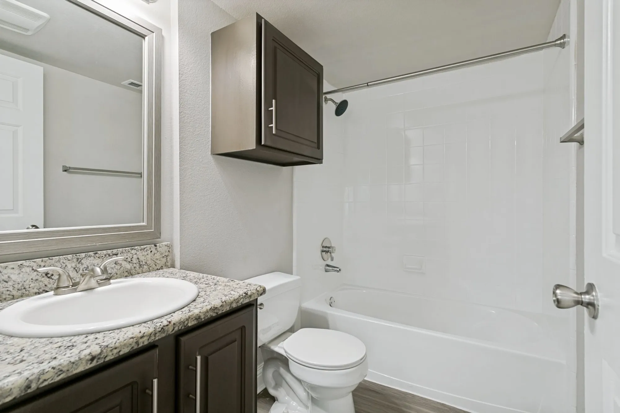 Bathroom with granite vanity and soaking tub at 29Fifty