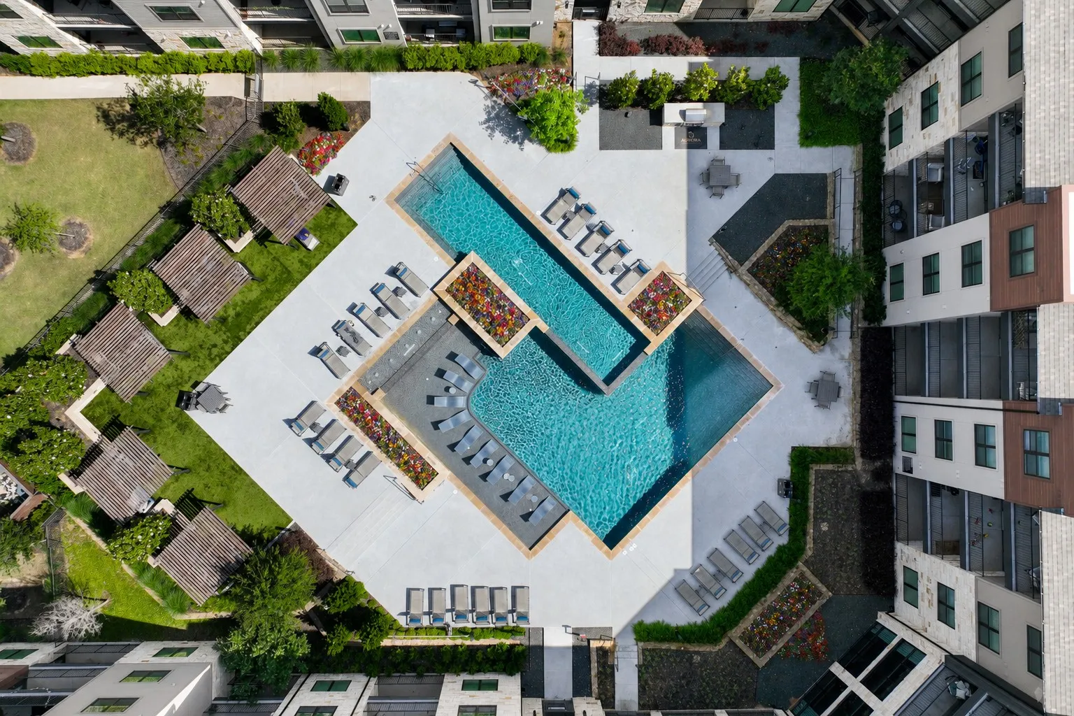 An aerial view of a pool surrounded by buildings