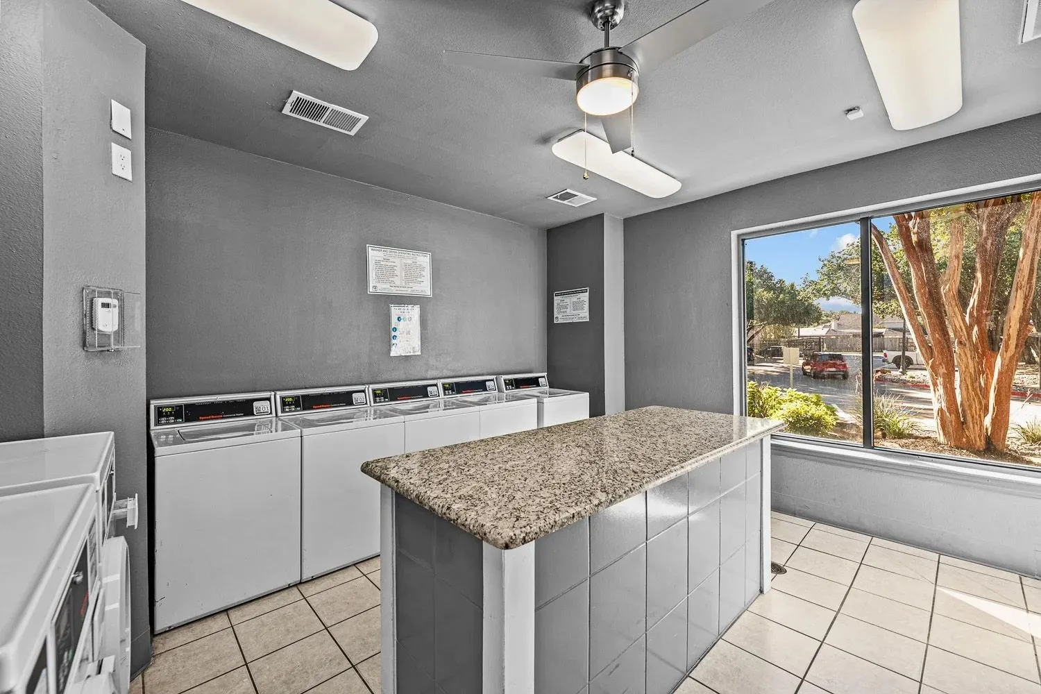 Laundry room with washers, dryers and folding counter at 29Fifty