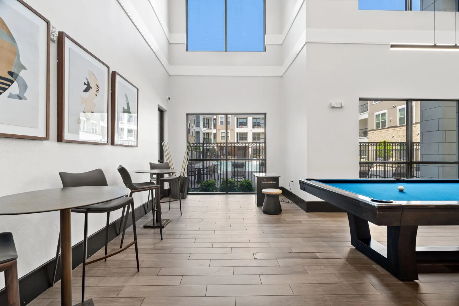 A room with a pool table and a view of the city. at Axis at Watters Creek