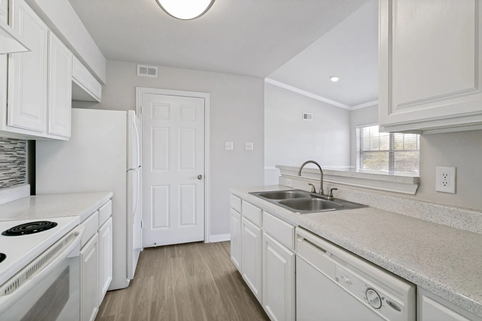 Kitchen with white cabinets and full-size appliances at 29Fifty