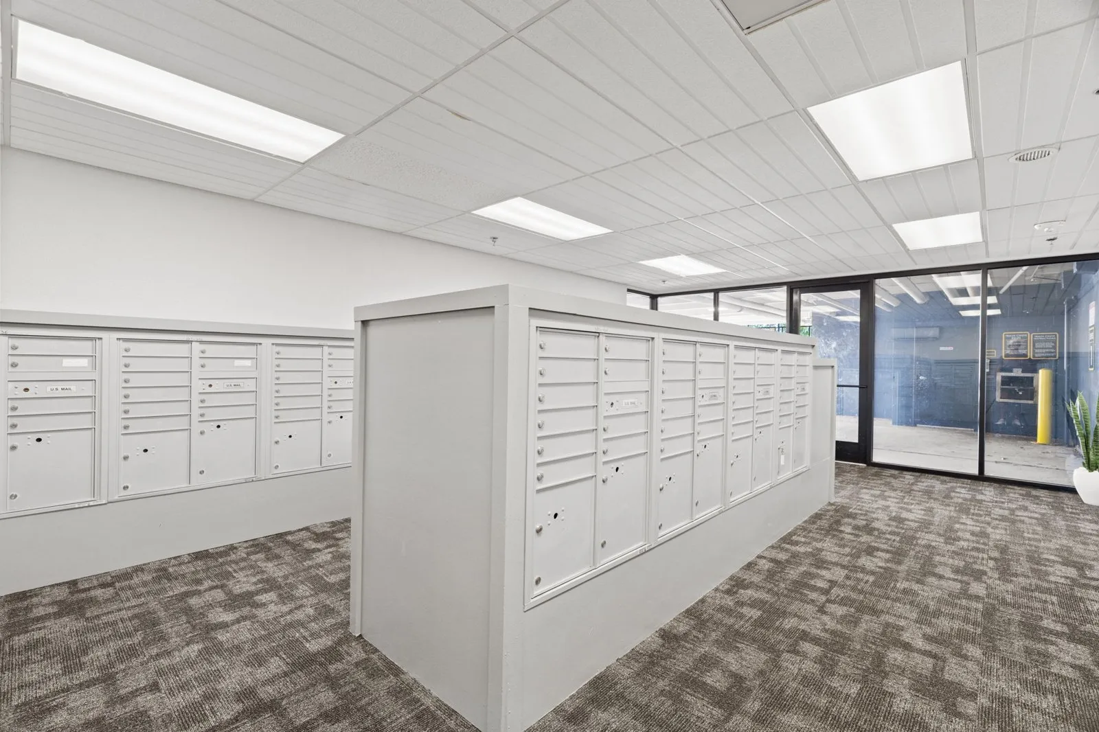A room with white cabinets and a grey carpet. at Axis at Watters Creek