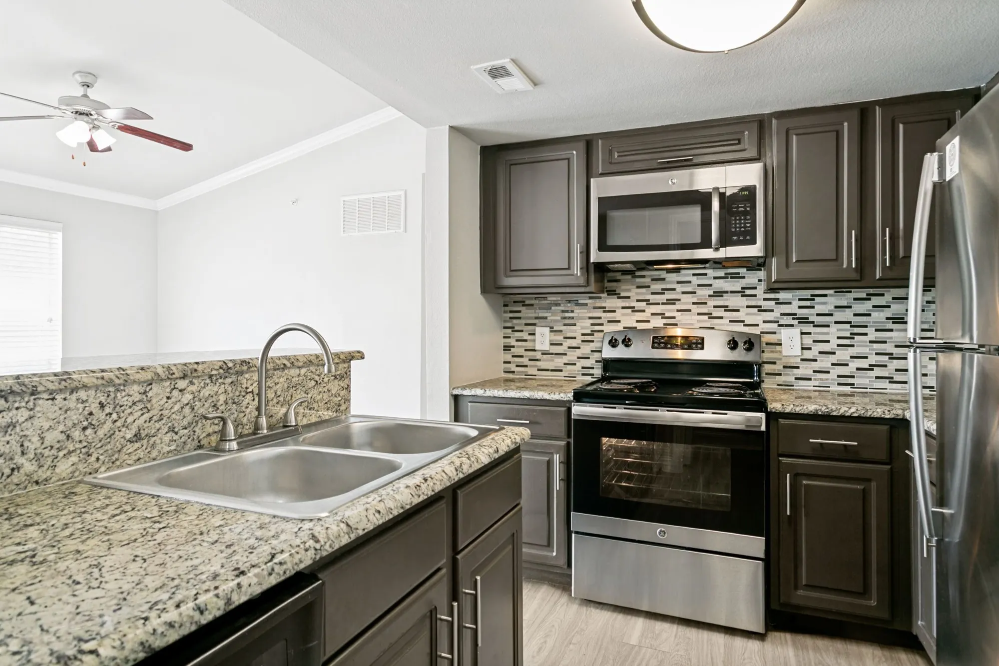 Kitchen with granite counters and dark cabinetry at 29Fifty