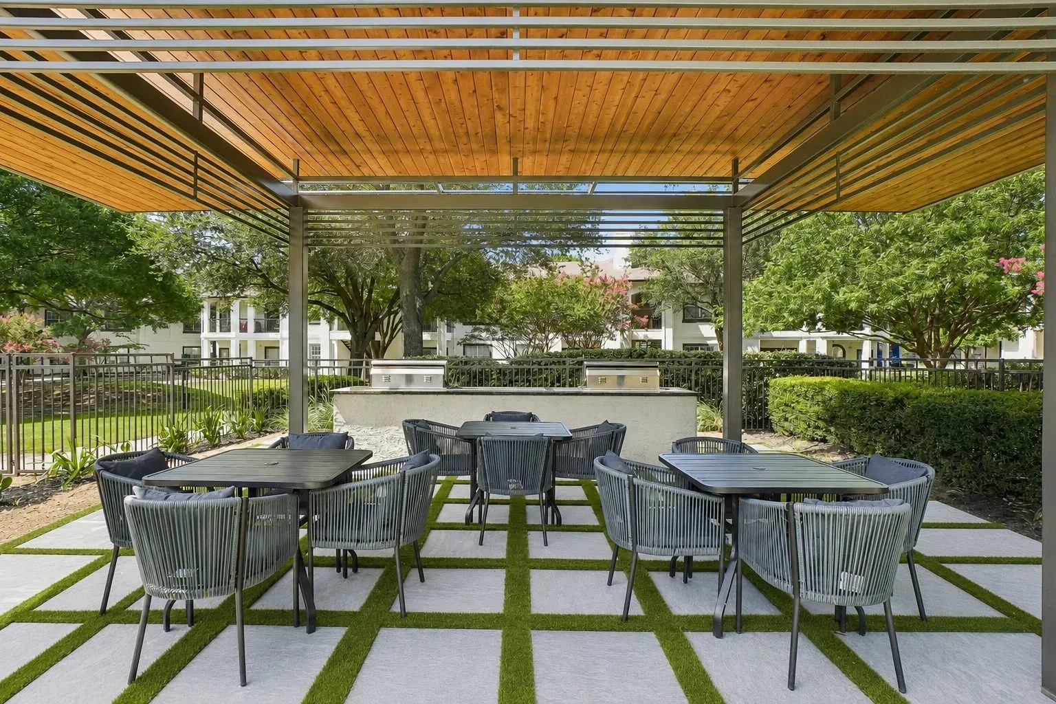 23Hundred at Ridgeview - A cozy outdoor dining area with tables and chairs under a wooden canopy