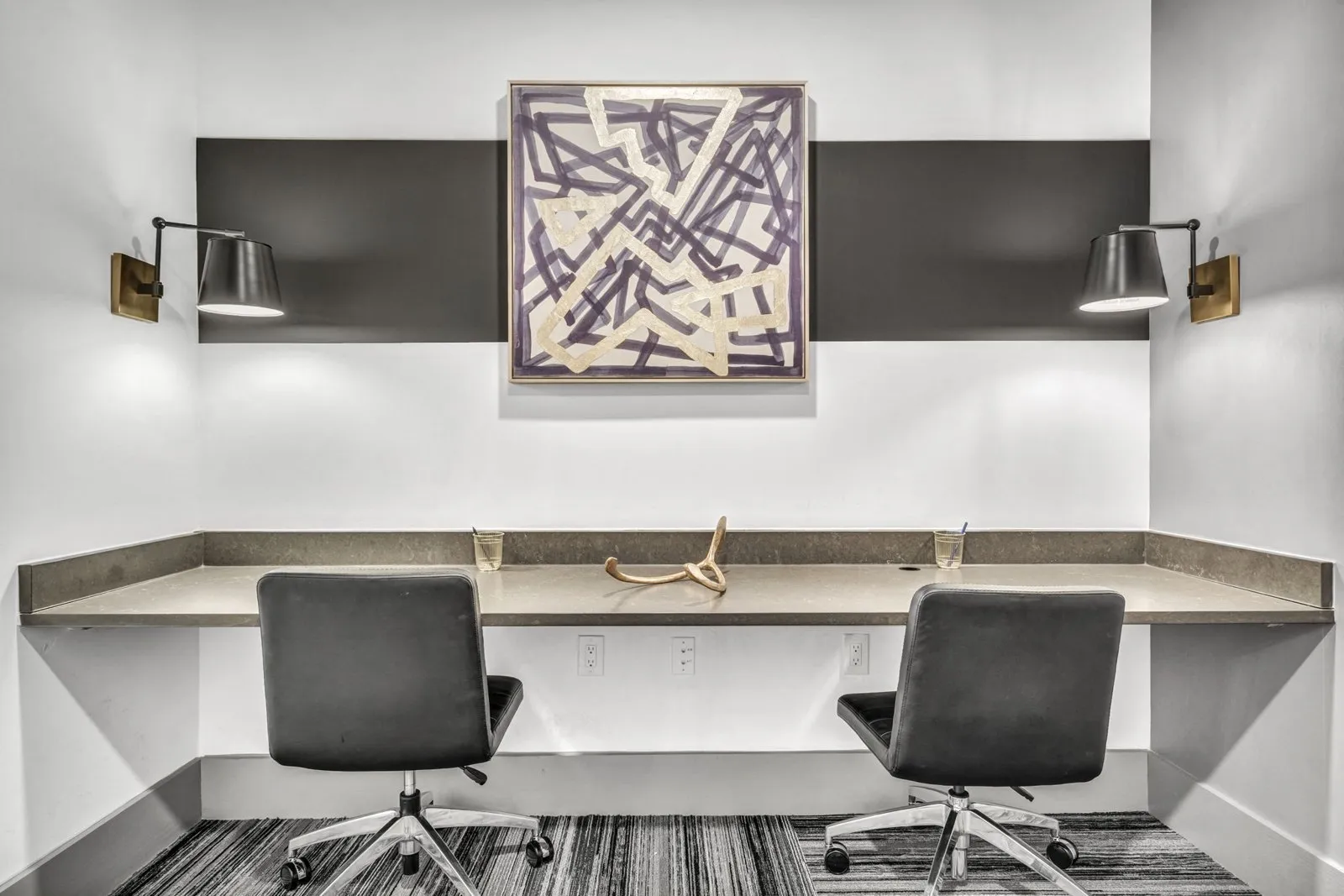 A modern office with a large abstract painting on the wall. at Axis Grand Crossing