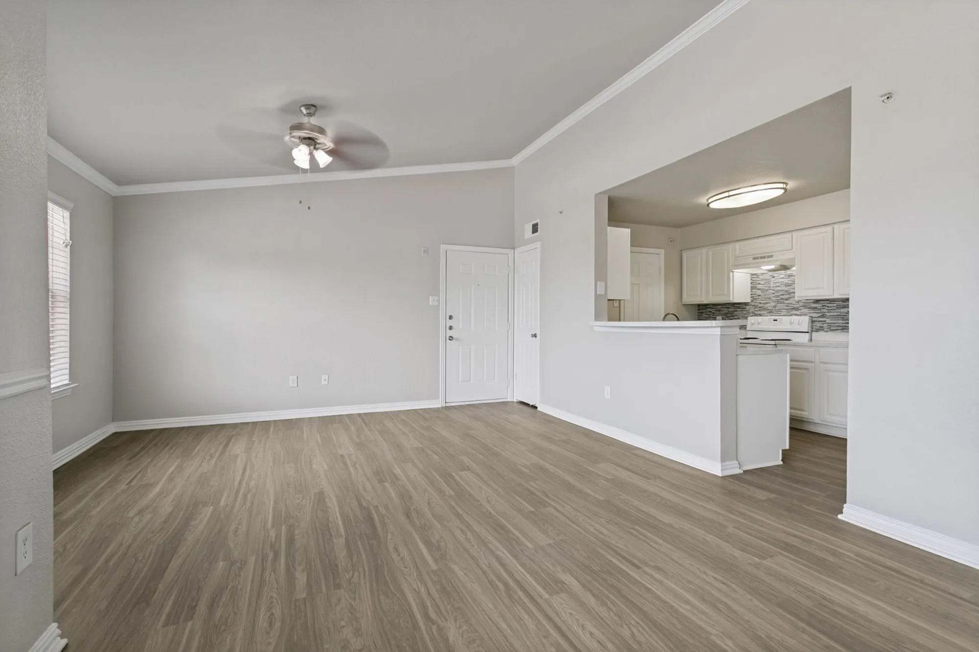 Living and dining area with ceiling fan at 29Fifty